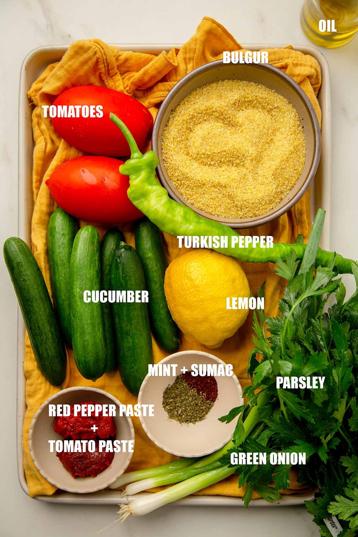 Ingredients to make kisir: tomatoes, cucumbers, bulgur, herbs and spices