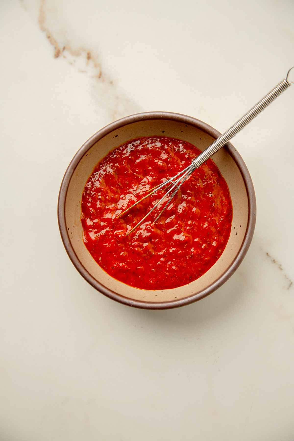 A red paste made with tomato paste, red pepper paste, lemon juice, olive oil, herbs and spices
