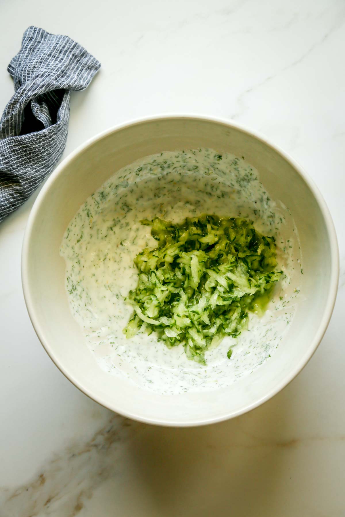 Shredded Cucumber in a Bowl of Seasoned Goat Milk Yogurt