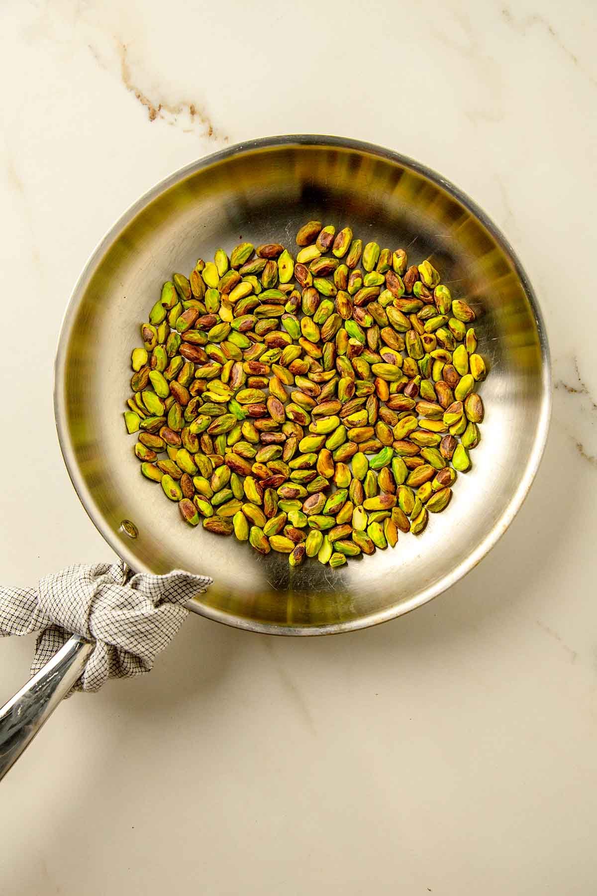 pistachio dry roasting in a skillet