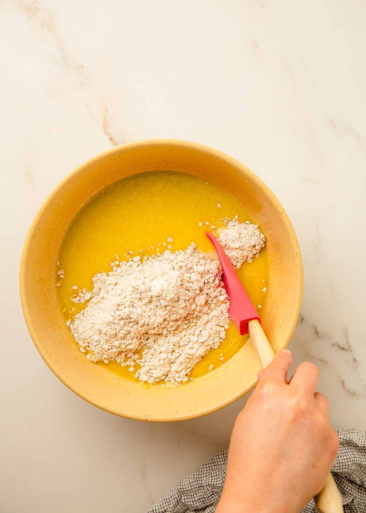 Flour, baking powder, cinnamon, and salt added to muffin batter.