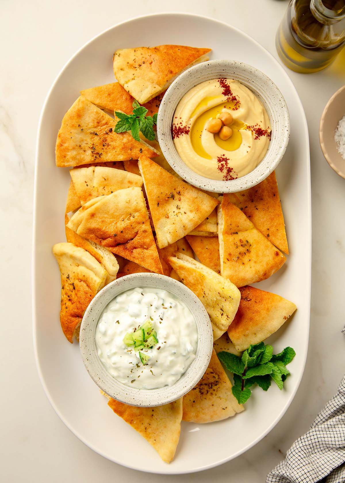 Homemade Pita Chips with Small Bowls of Tzatziki and Hummus
