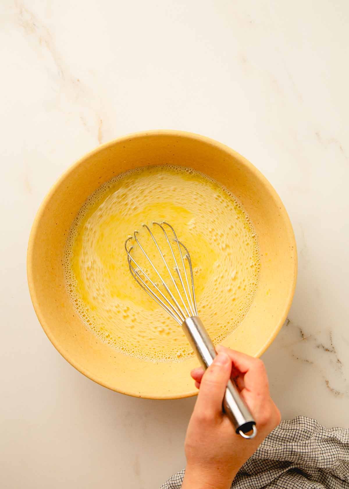 Whisking Wet Ingredients in Large Yellow Bowl