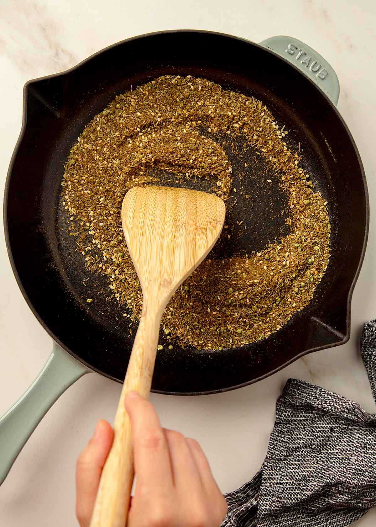 herbs and spices dry roasting on a skillet