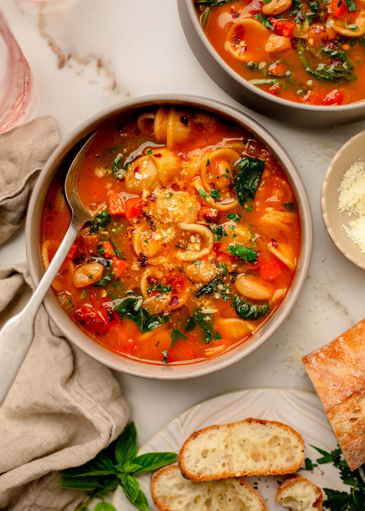 Orecchiette soup served with grated Parmesan on top.
