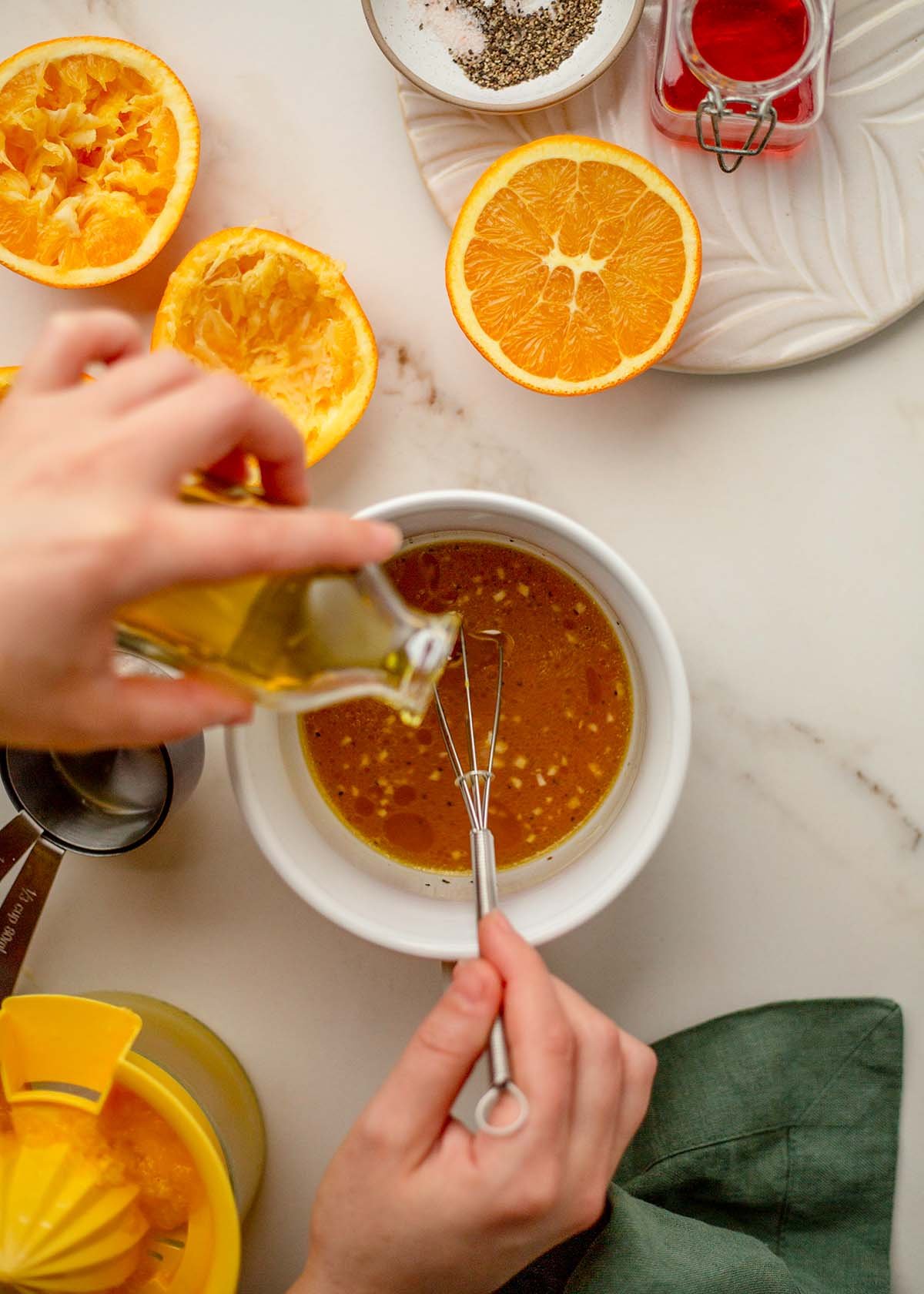 Adding olive oil to orange vinaigrette