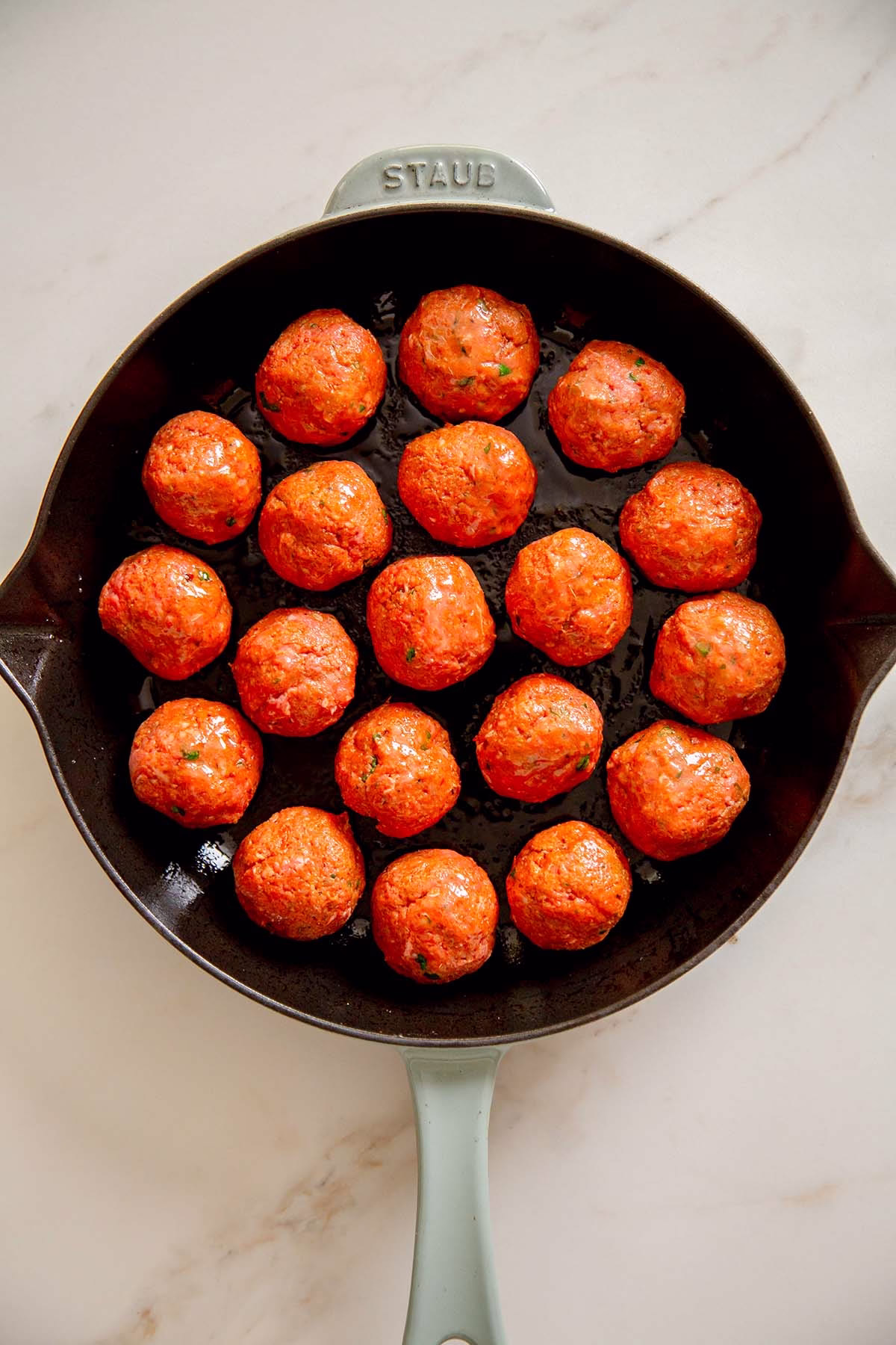 meatballs in a skillet before cooking