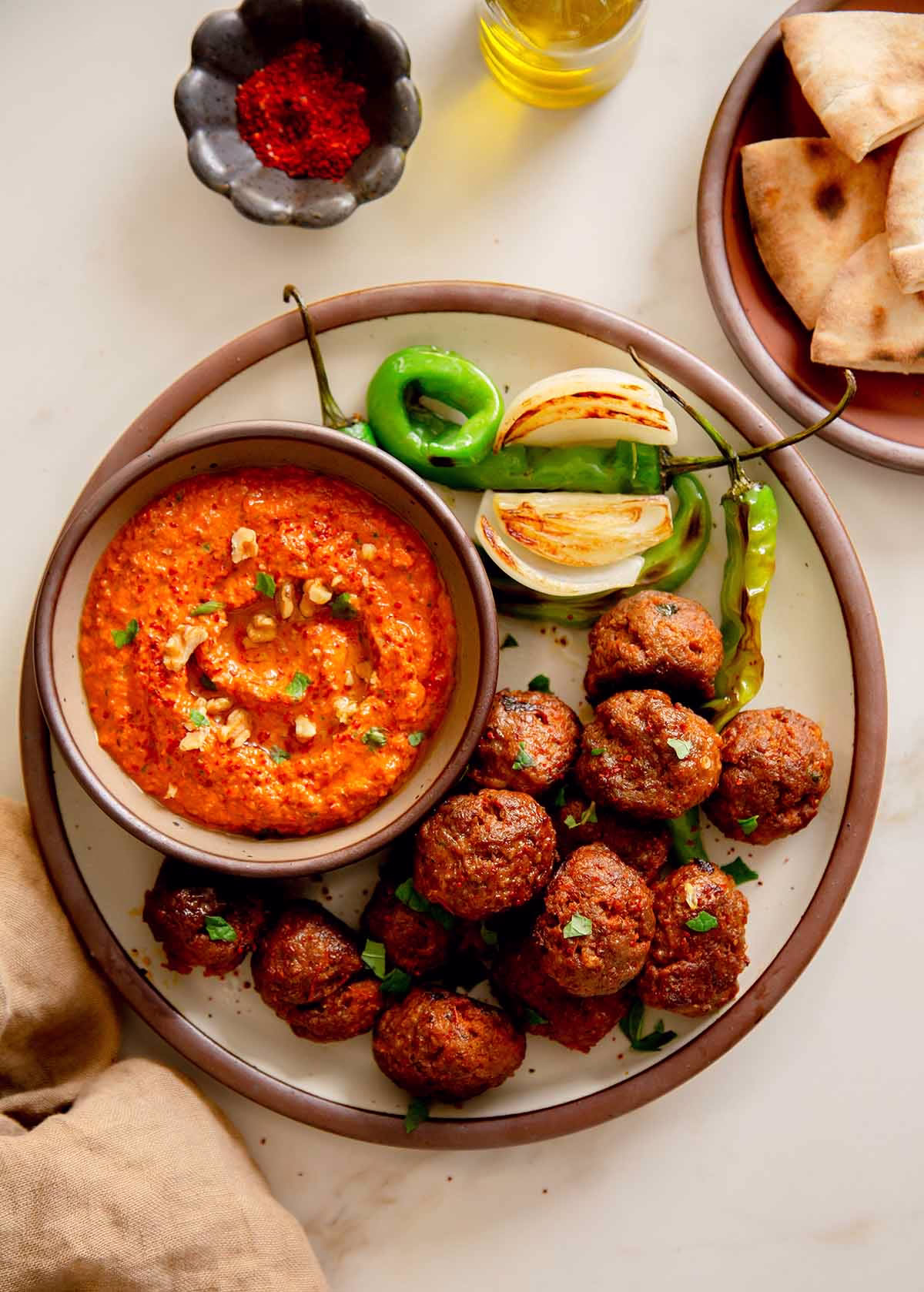 muhammara meatballs served with muhammara sauce and grilled vegetables