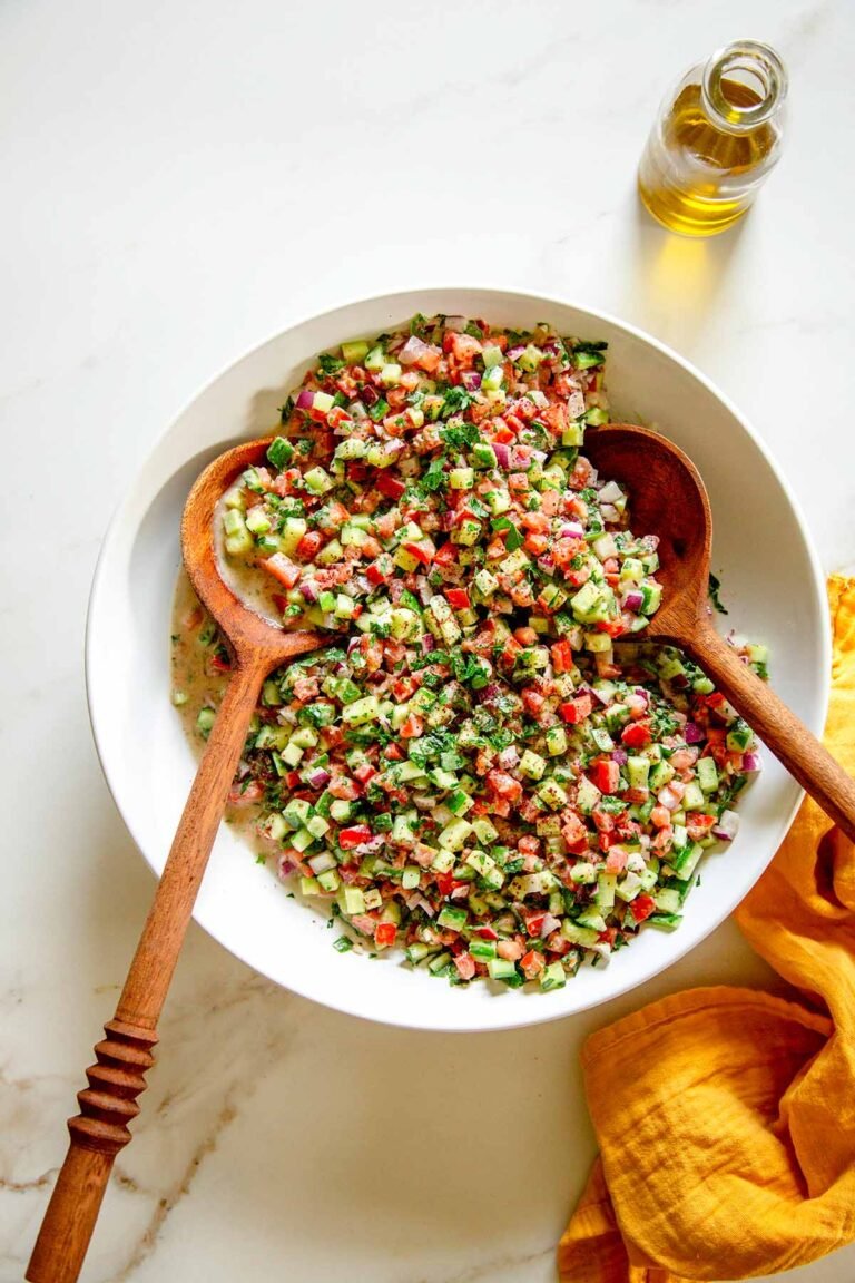 Easy Tahini Salad Recipe in a large white bowl with a set of wooden spoons