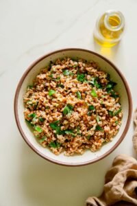 Farro in a bowl with lemon, olive oil, and fresh herbs