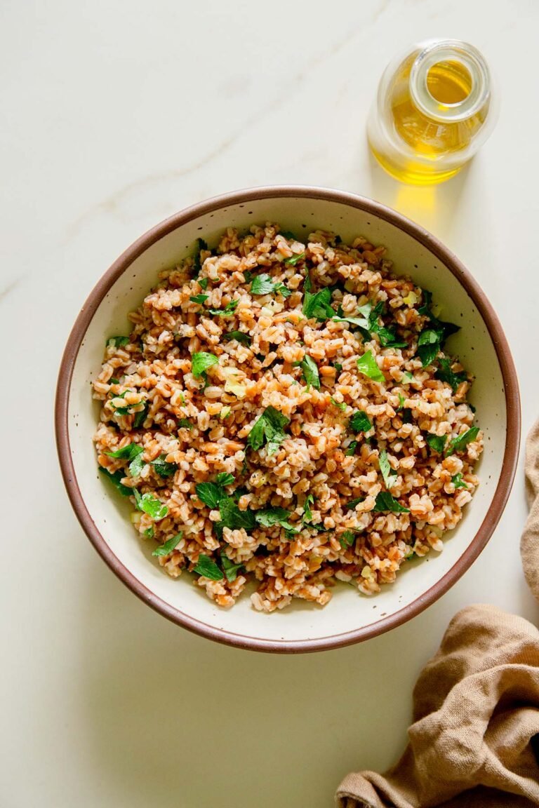 Farro in a bowl with lemon, olive oil, and fresh herbs