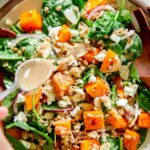 Fall butternut squash salad with farro, spinach, red onion, and feta. Cinnamon tahini spooned on top.