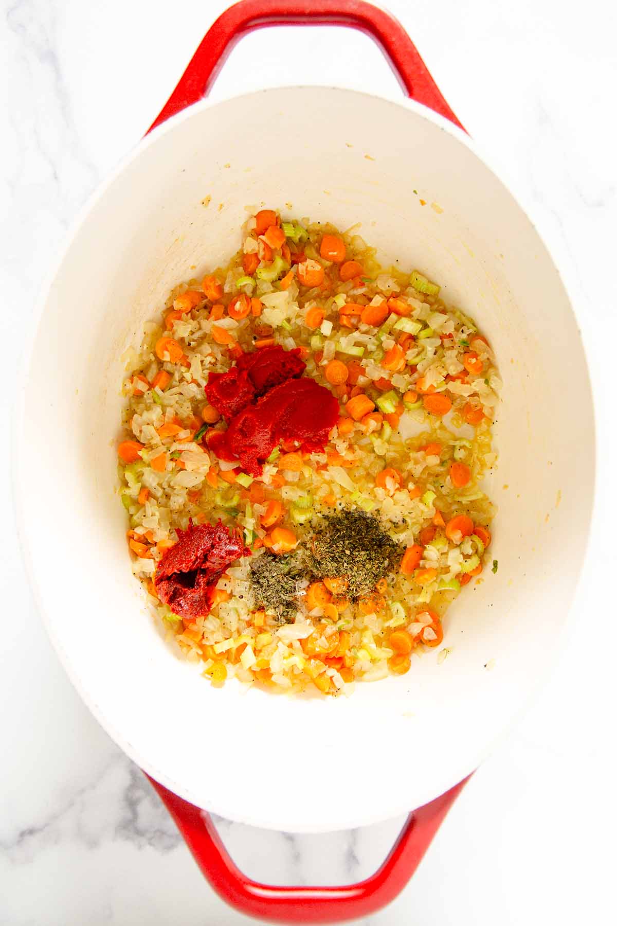 carrots, onions, celery sautéing in a pot with Turkish red pepper paste and tomato paste