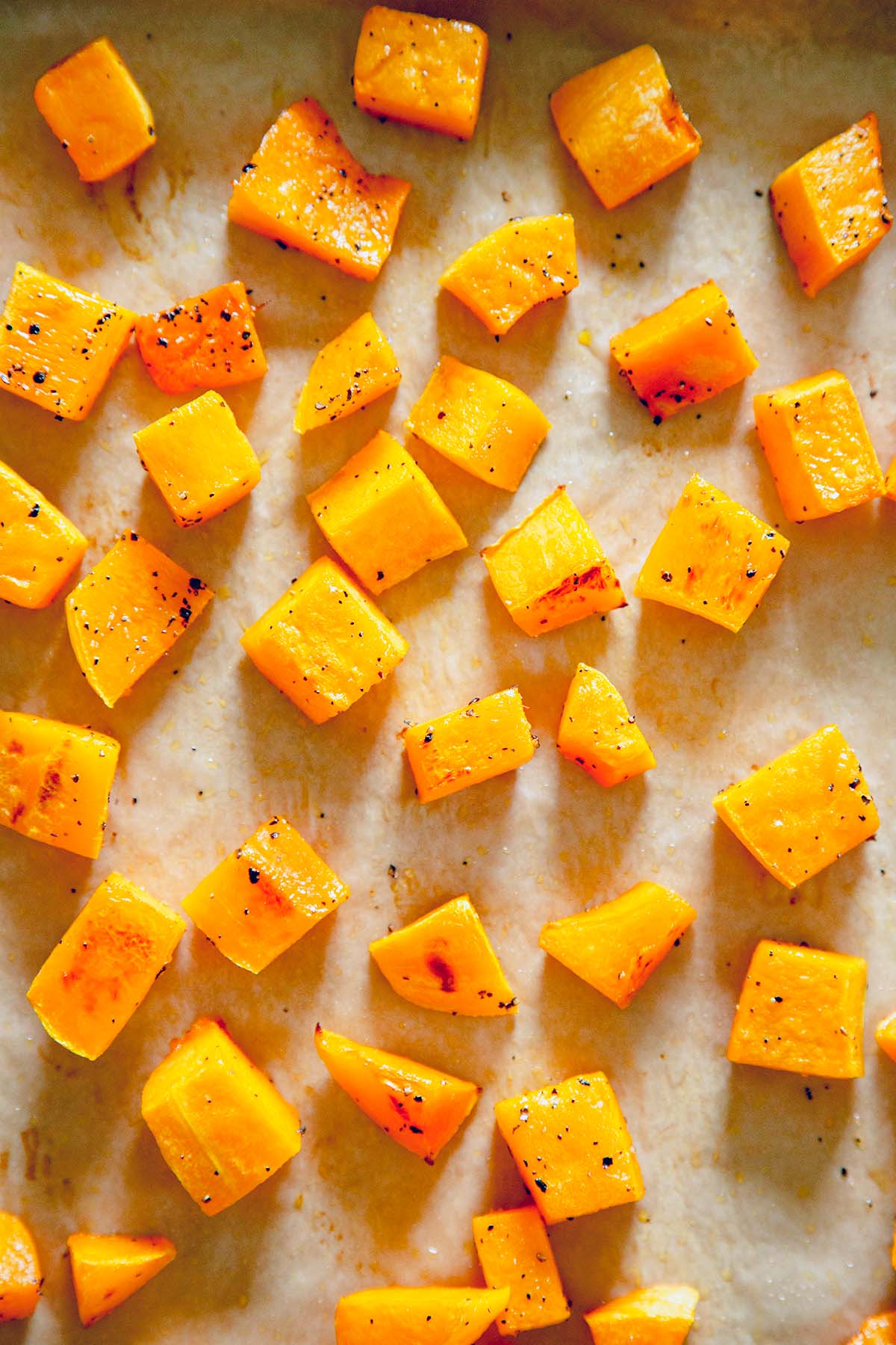 diced butternut squash roasted on a sheetpan