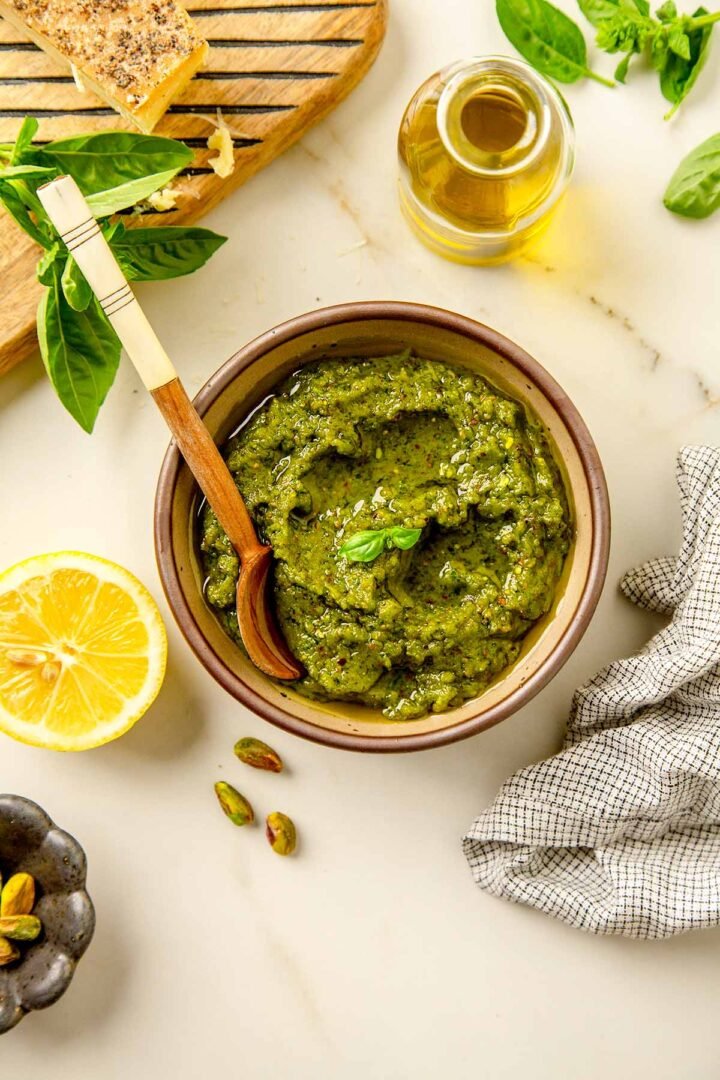 pistachio pesto in a bowl with a wooden spood