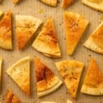 Crispy baked pita chips cooling on a tray