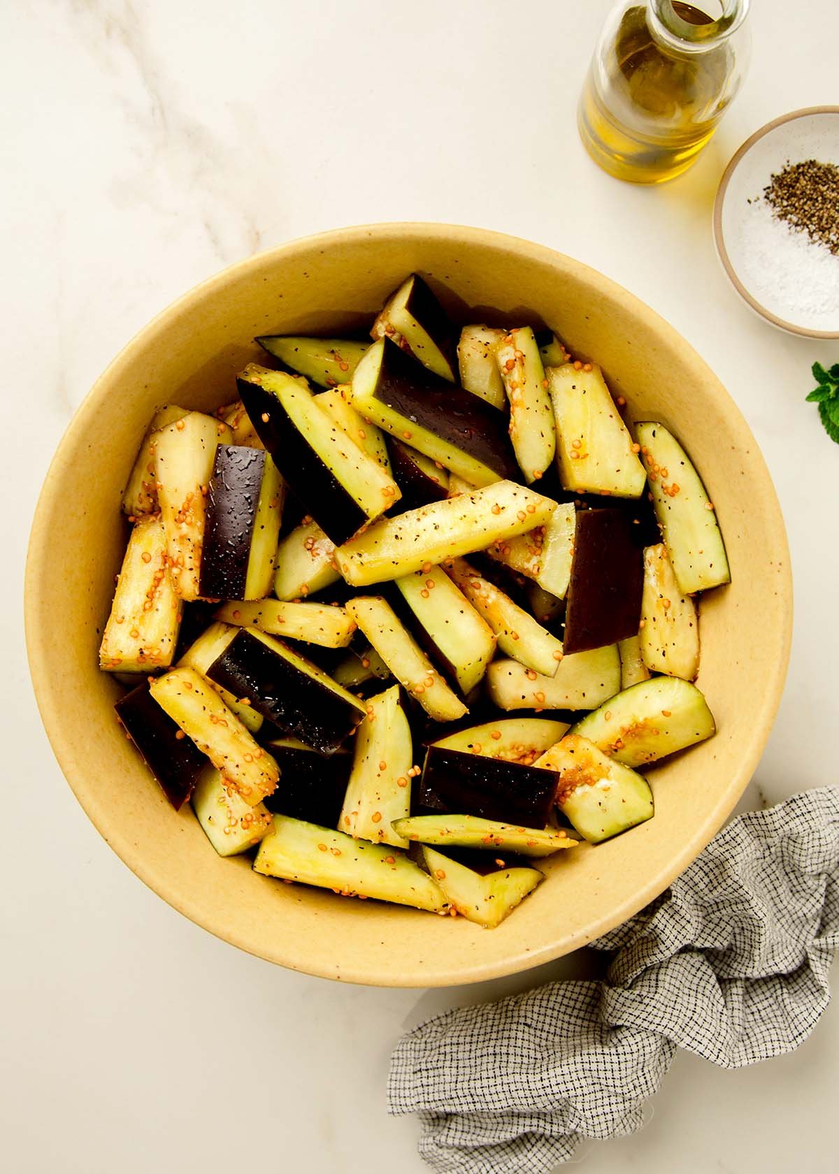 Prepped eggplant in yellow bowl