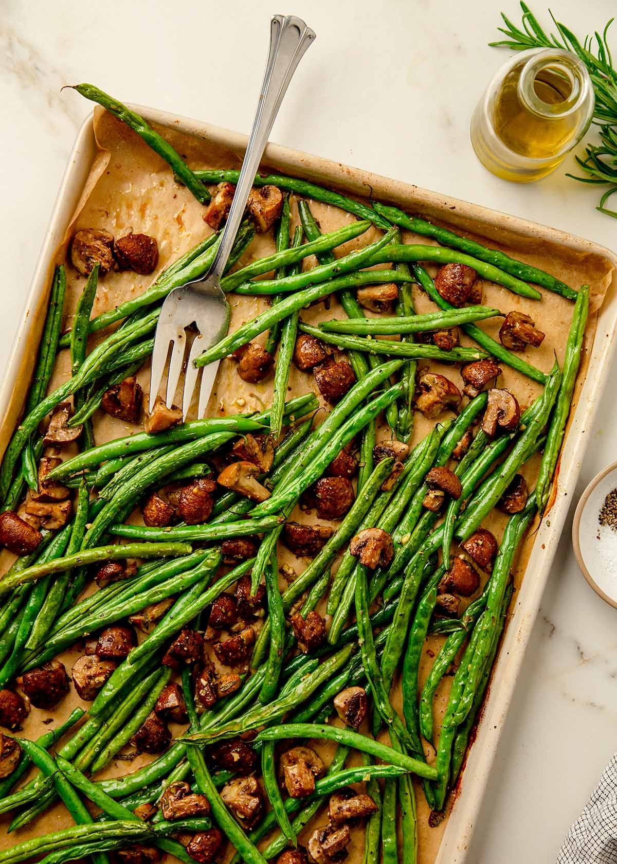 Roasted green beans with mushrooms fresh from the oven on baking sheet