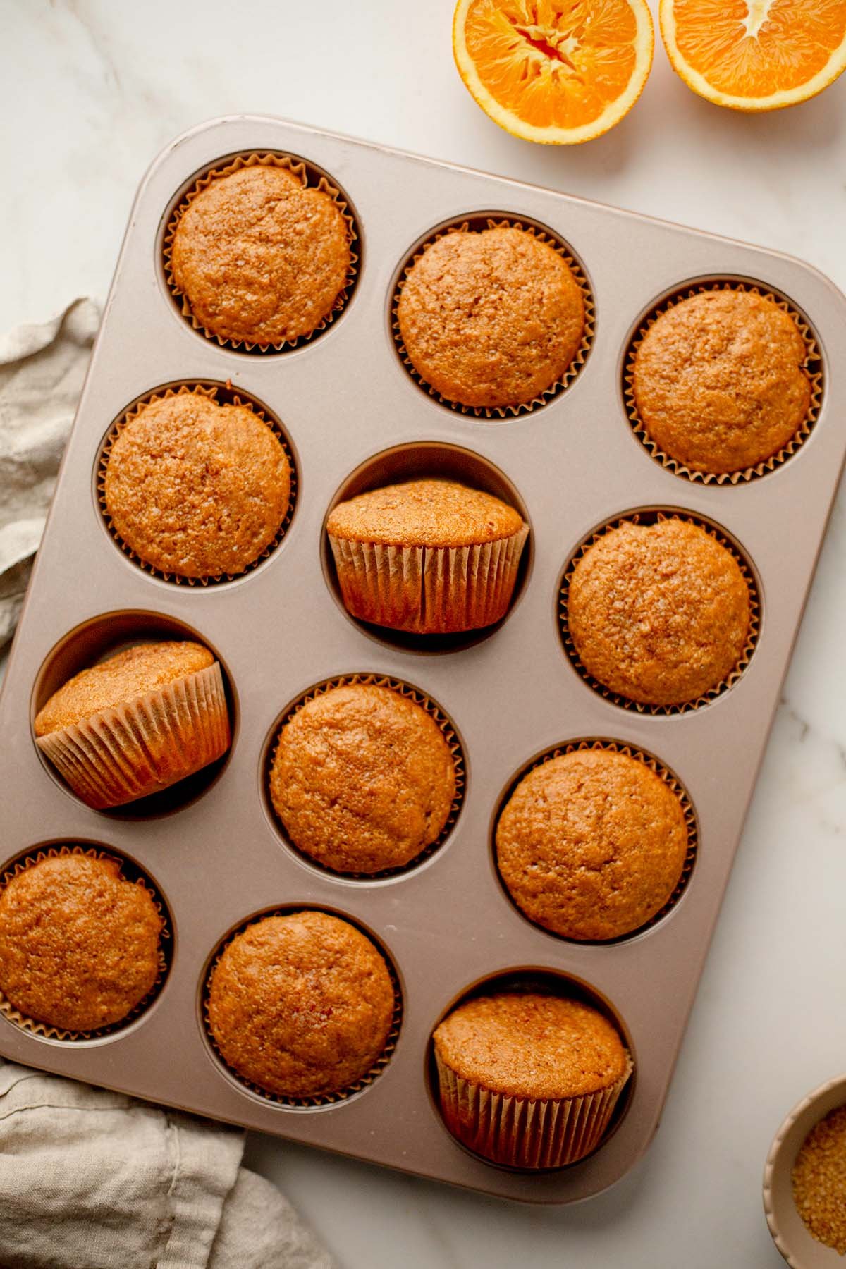 Baked orange spice pumpkin banana muffins in tin