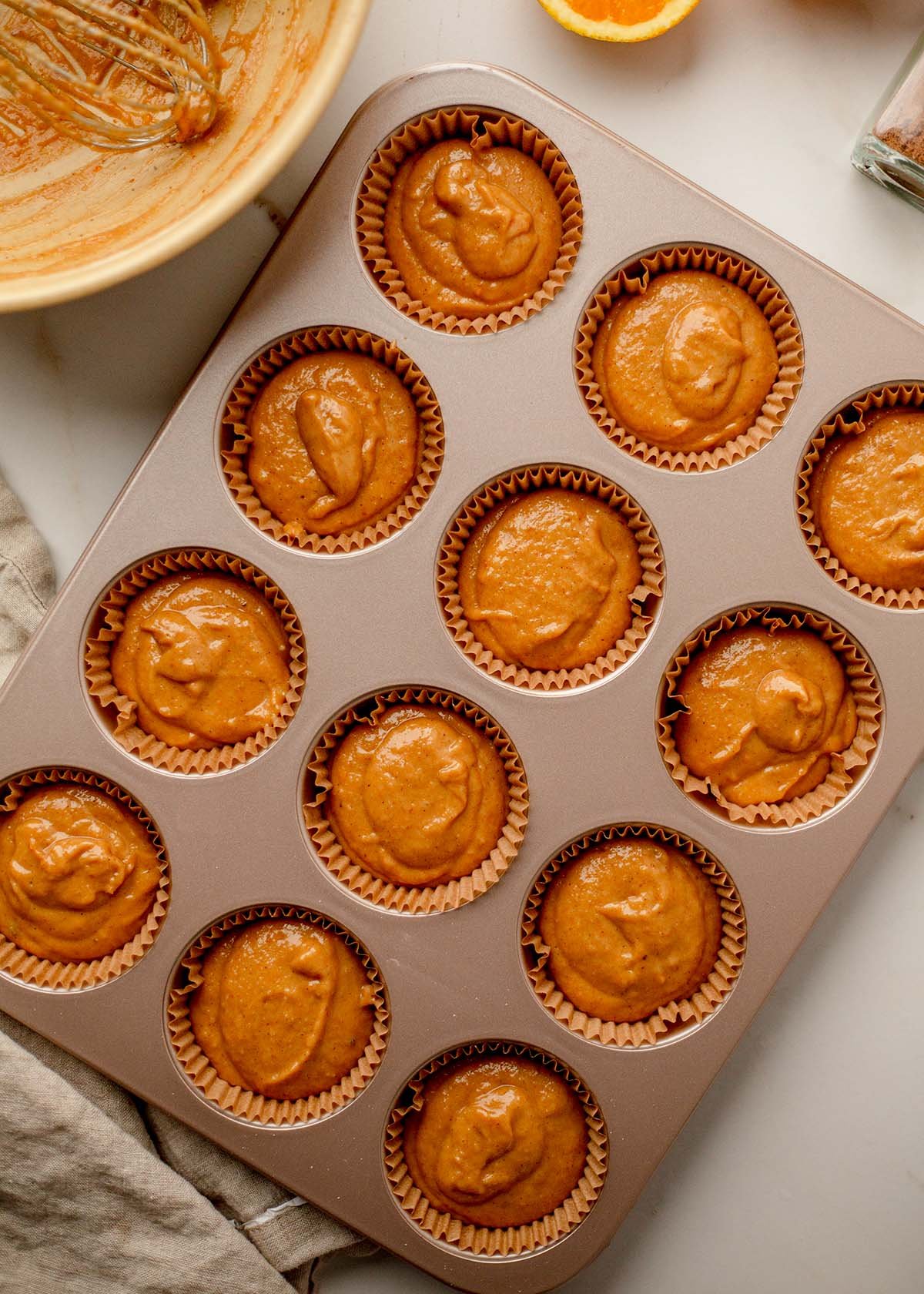Pumpkin banana muffins in tin ready to bake