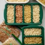 Quinoa, farro, brown rice, and couscous stored in meal prep containers and ZipLoc bags