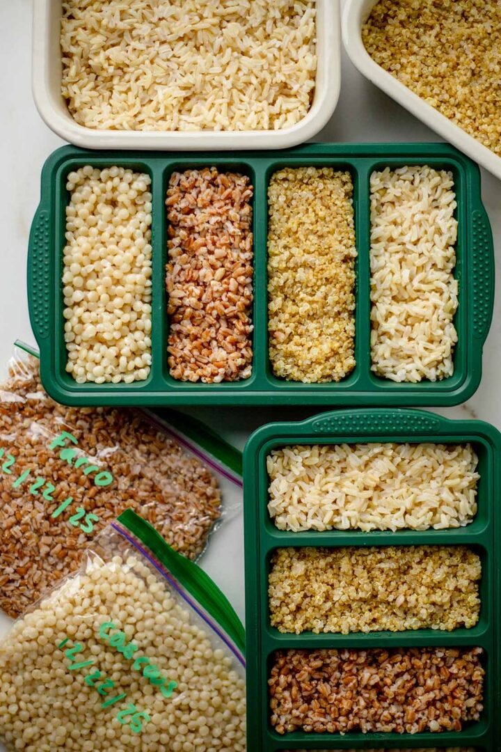 Quinoa, farro, brown rice, and couscous stored in meal prep containers and ZipLoc bags