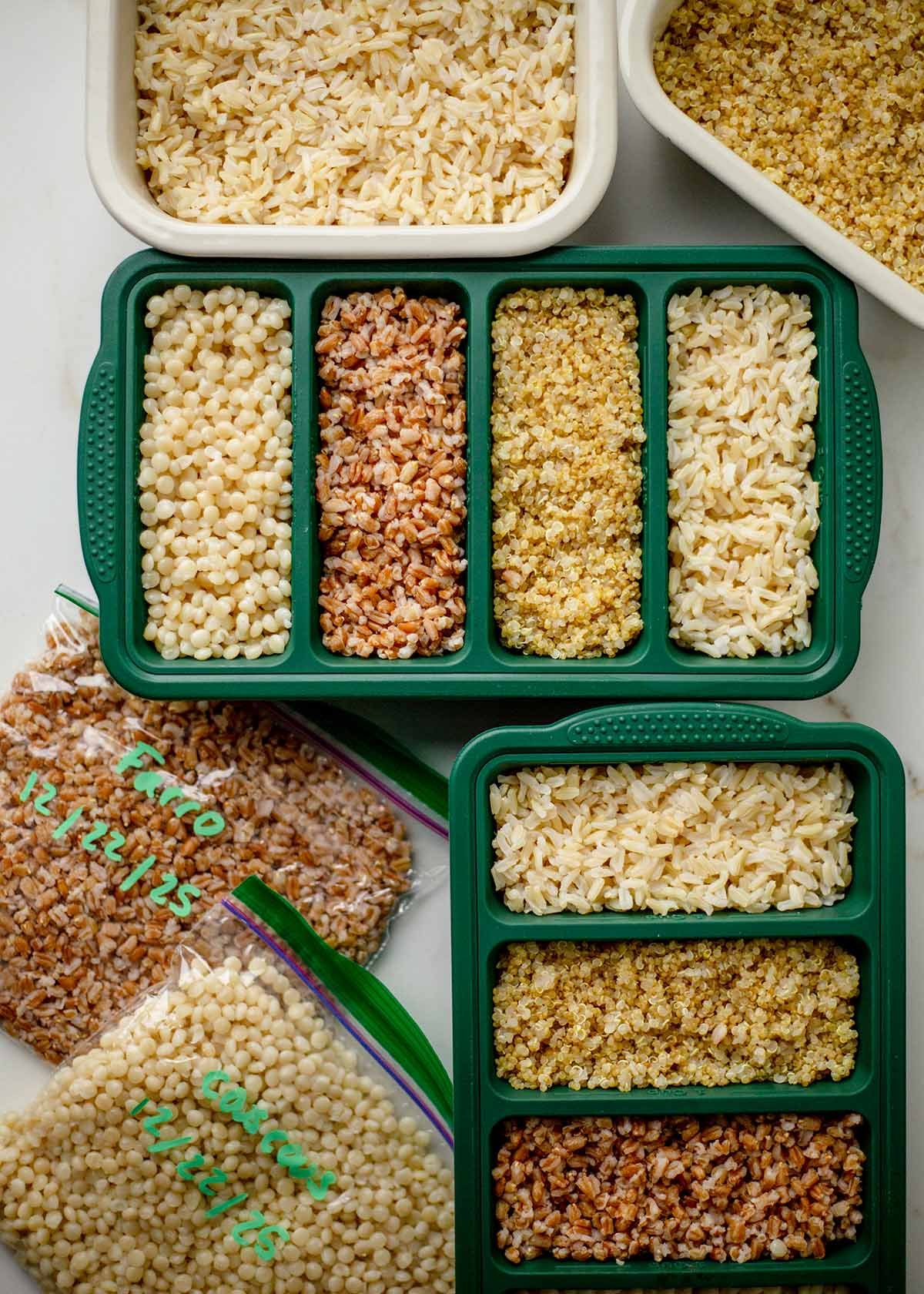 Quinoa, farro, brown rice, and couscous stored in meal prep containers and ZipLoc bags