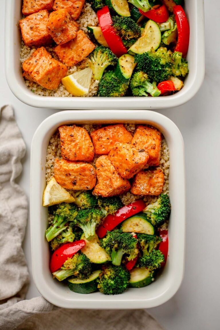 Lemon herb salmon lunch prep bowl packaged in a reusable container with the lid secured for easy work lunches.