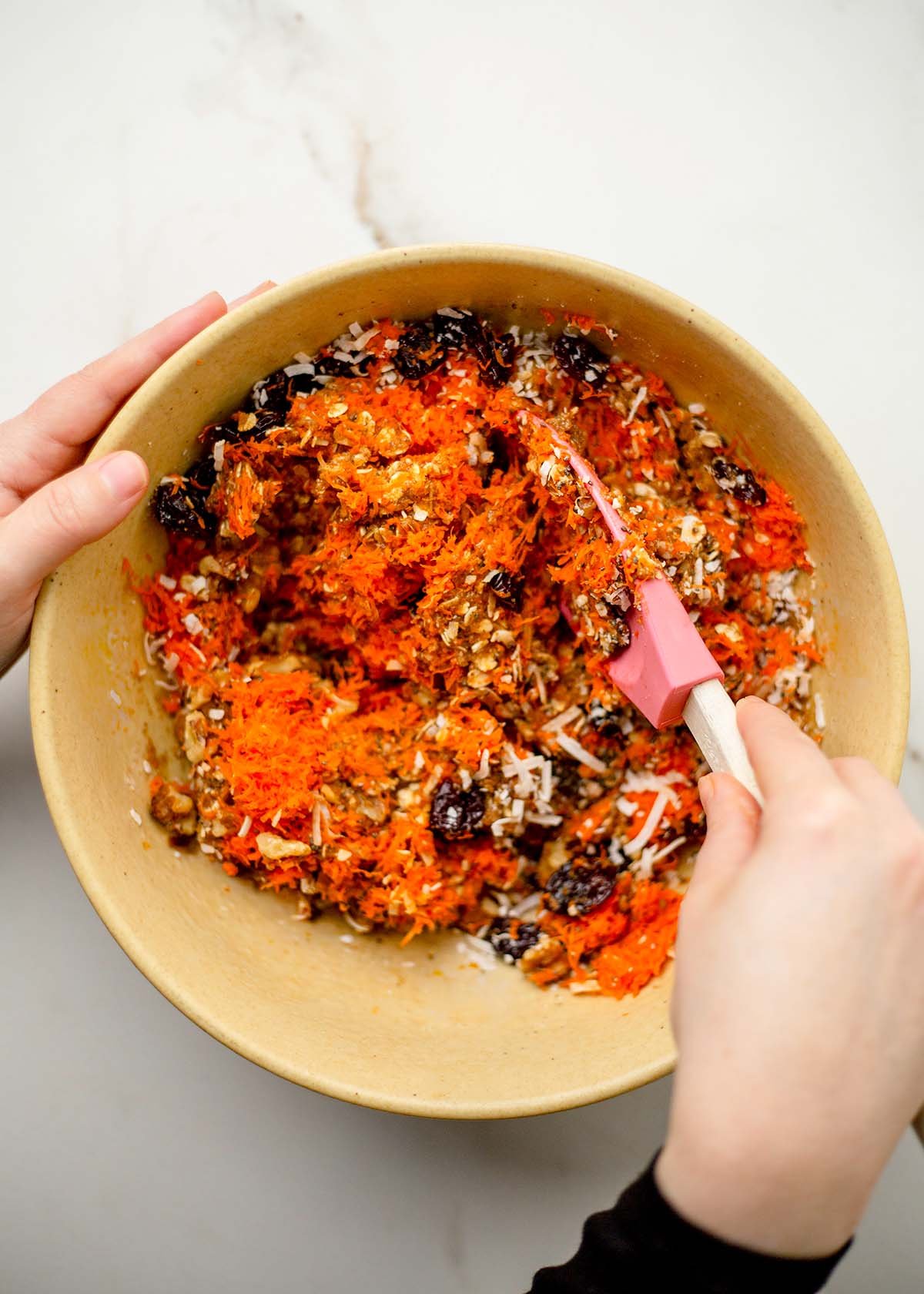 Morning glory cookie dough being mixed in one bowl.