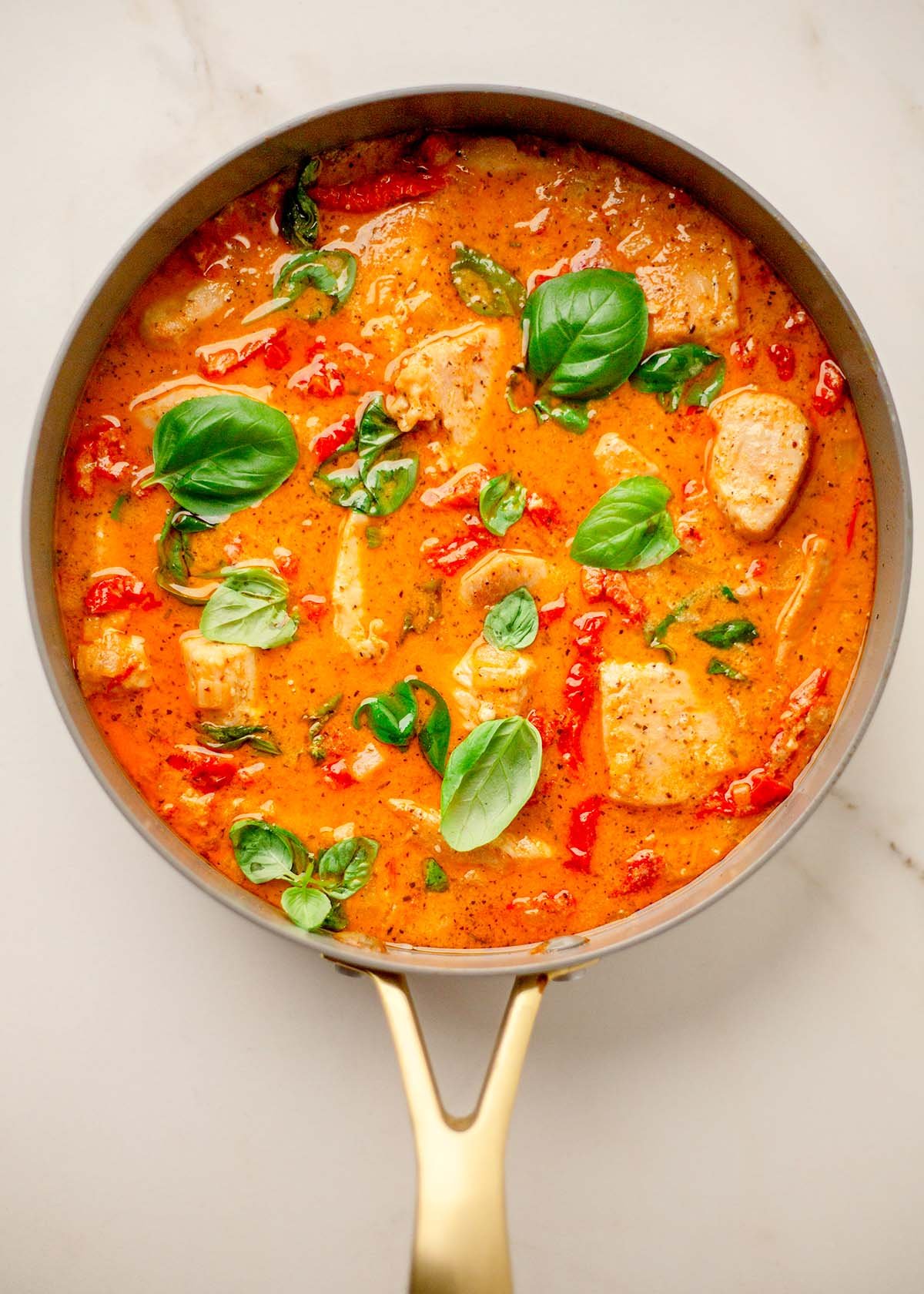 High-Protein Mary Me Chicken in a grey skillet with golden handle.