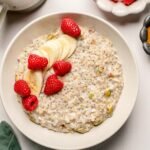 protein oatmeal with fresh raspberries and bananas on top