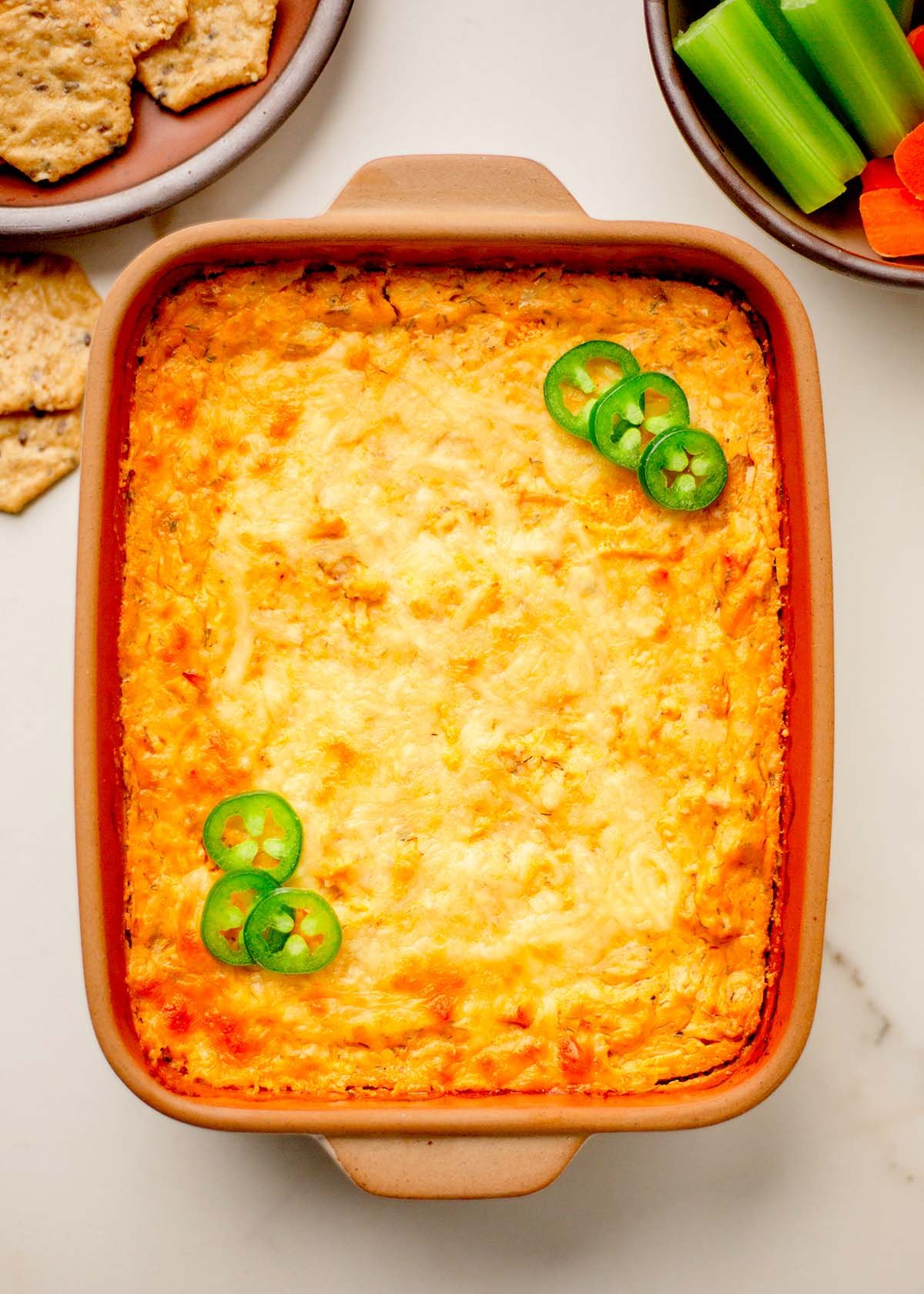 Serving high protein buffalo chicken dip with veggie dippers