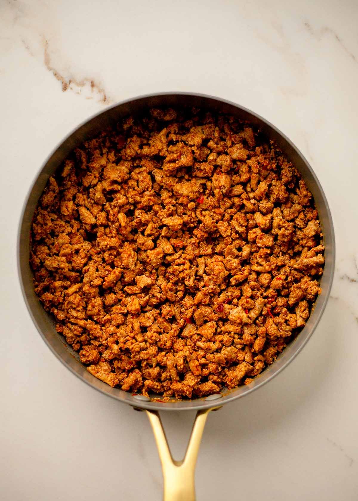 Taco seasoned ground turkey cooking in a skillet