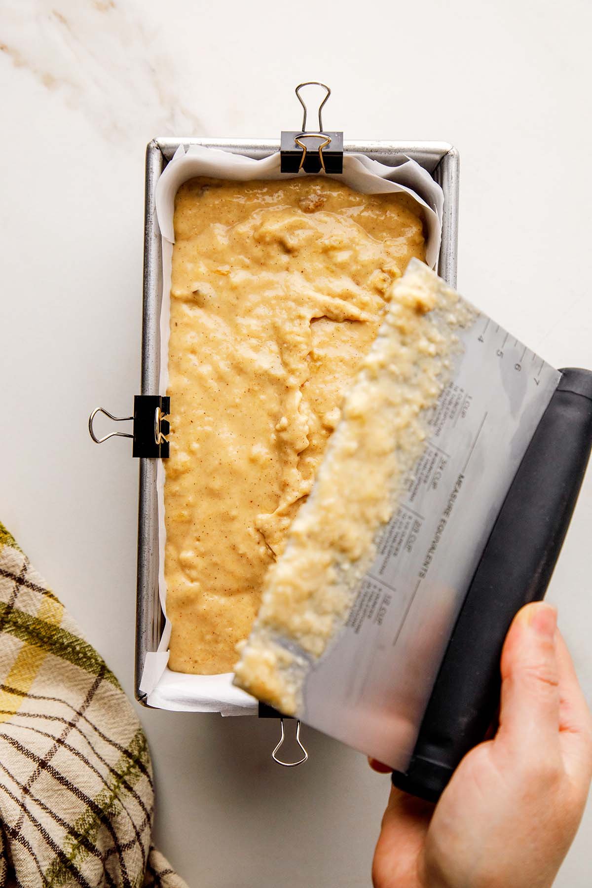 Placing Bench Scraper into Honey Banana Bread Batter Before Baking